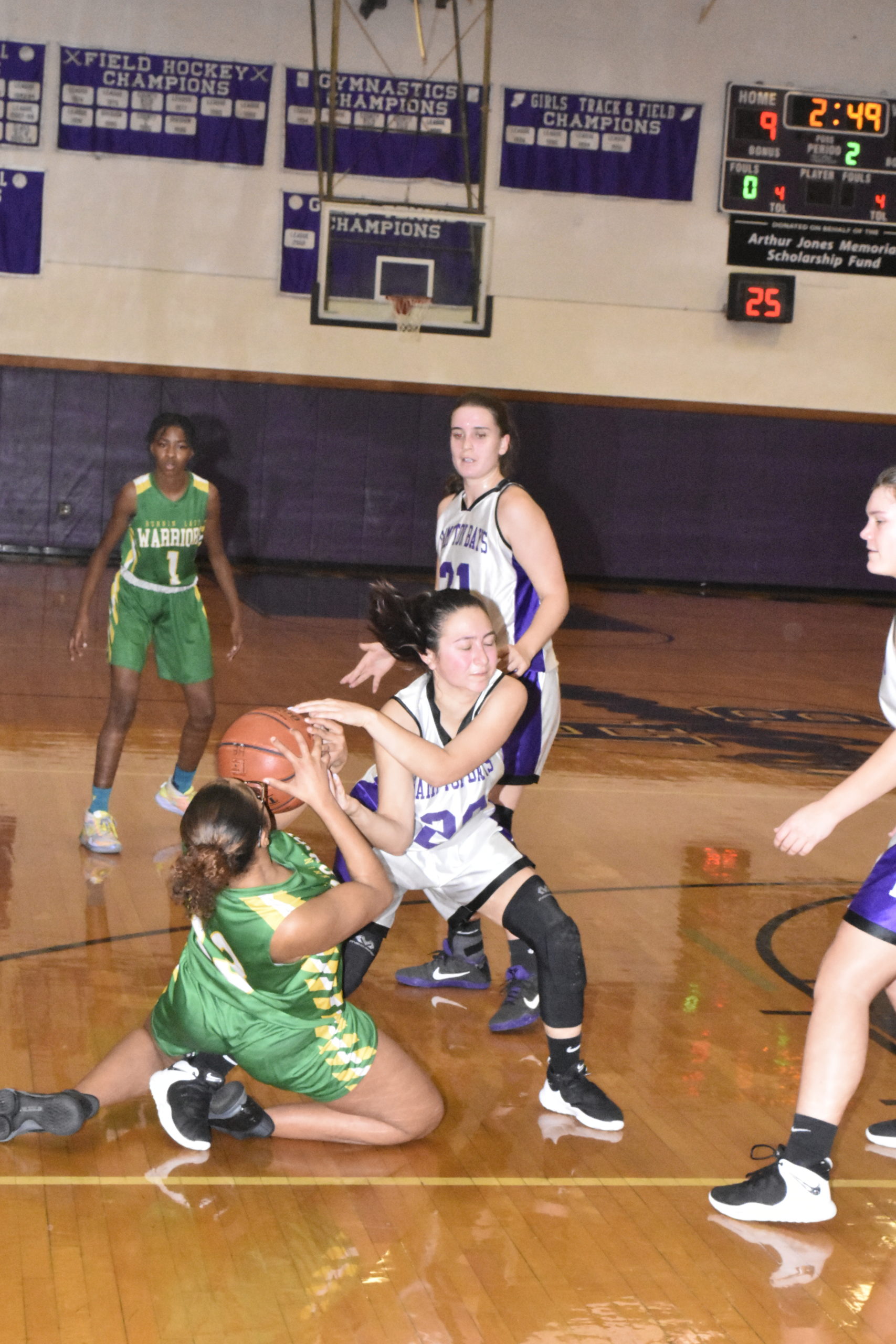 Hampton Bays senior Pam Grajales ties up with a Wyandanch player to force a jump ball.