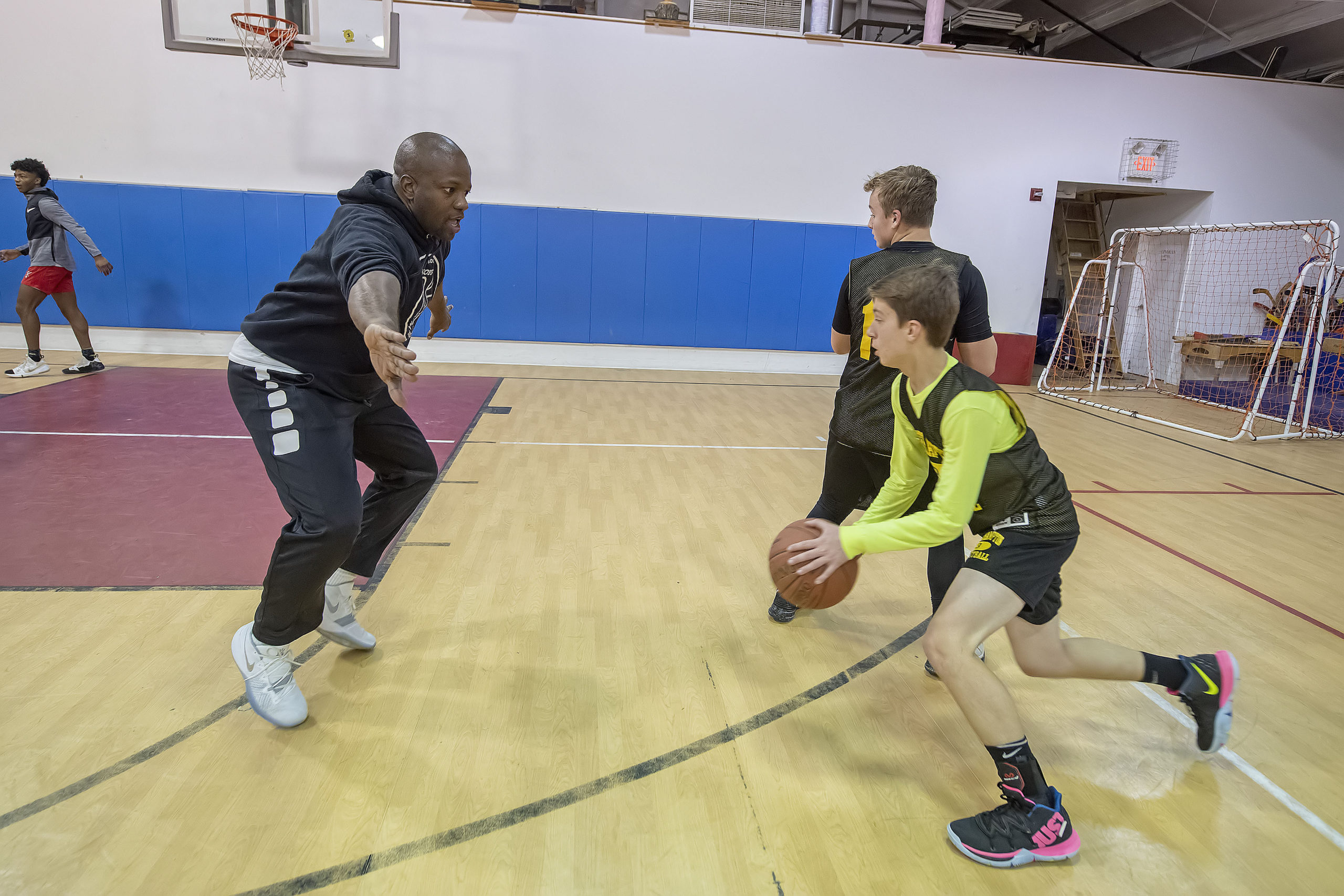 Coach Ron White runs his young Killer Bees team through some practice drills on Monday night at Hayground School.