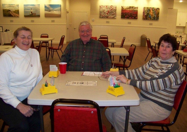 Leo Kimmel; Kathie Mclauchlen; Marianne Carroll at the new home of the Water Mill Bridge Club.
