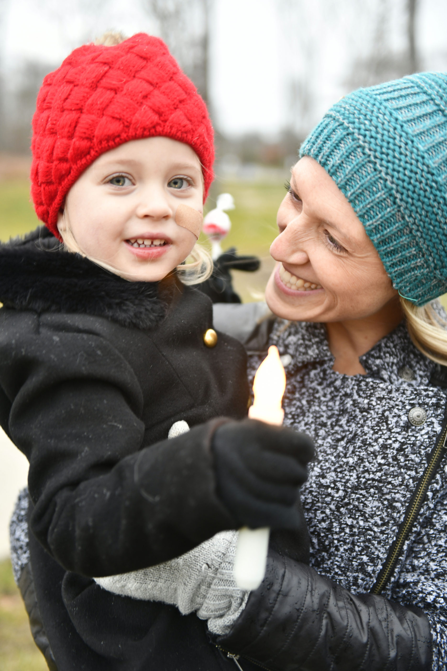 Grace and Brittany Carleton watch the tree lighitng at Good Ground Park in Hampton Bays on Friday.  DANA SHAW