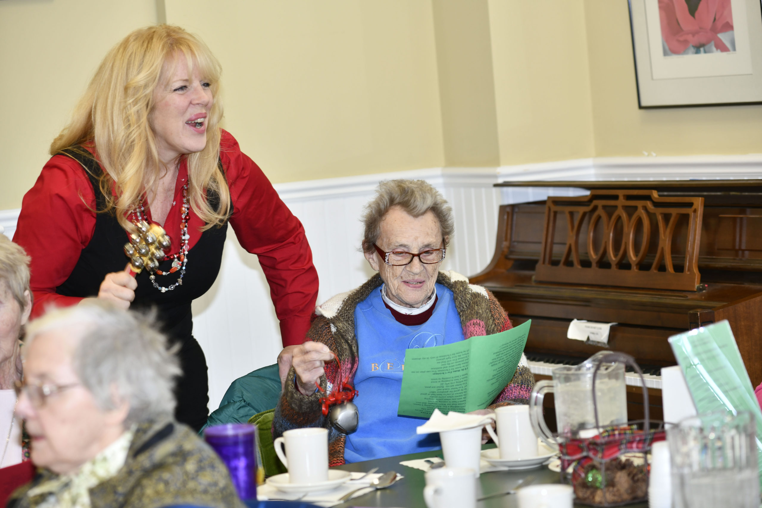 Valerie diLorenzo and Jean Carvis sing a carol.
