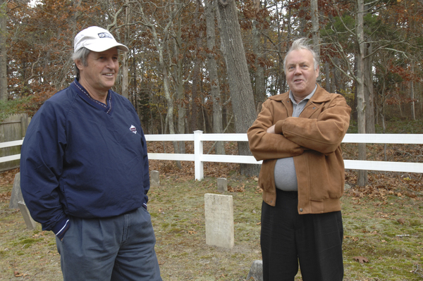 Dennis Delaney and  Zach Studenroth with Samuel E. Robinson's gravestone in the Squires (Fournier) Burying Ground Hampton Bays.  DANA SHAW