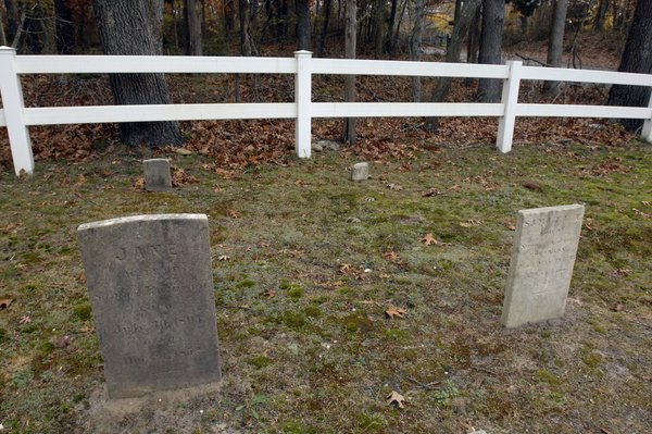 Dennis Delany and  Zach Studenroth in the Squires (Fournier) Burying Ground Hampton Bays.  DANA SHAW