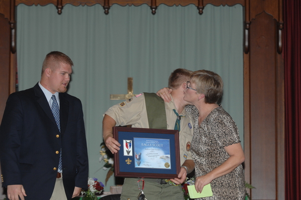 Andy Fowler receives his Eagle Scout medal and certificate from his brother Ricky and his mother Midge. 