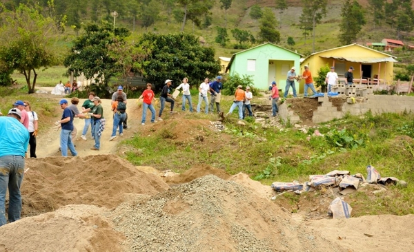 Southampton Intermediate School Assistant Principal Susan Wright participates in a bucket brigade to deliver supplies and materials to a school she helped build in the Dominican Republic.
