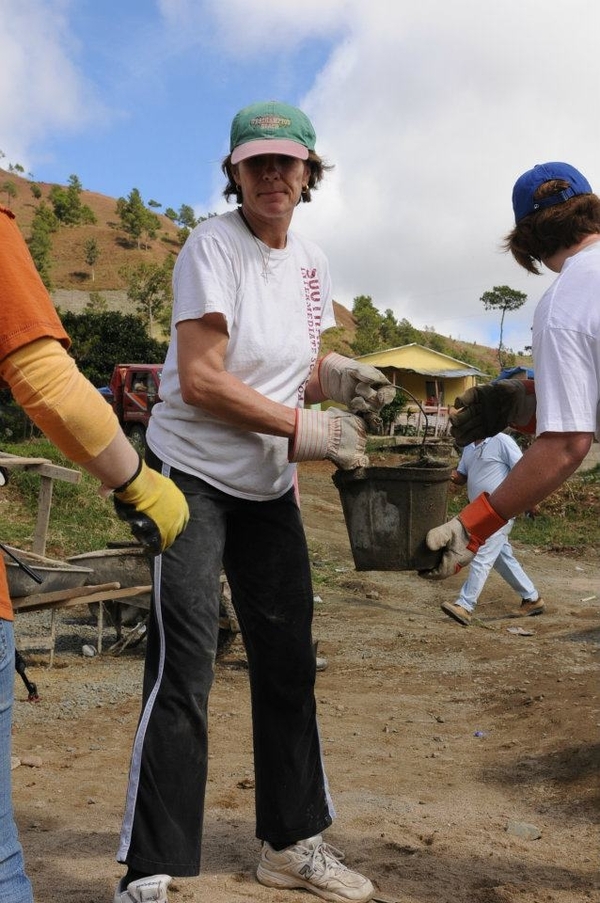 Southampton Intermediate School Assistant Principal Susan Wright participates in a bucket brigade to deliver supplies and materials to a school she helped build in the Dominican Republic.
