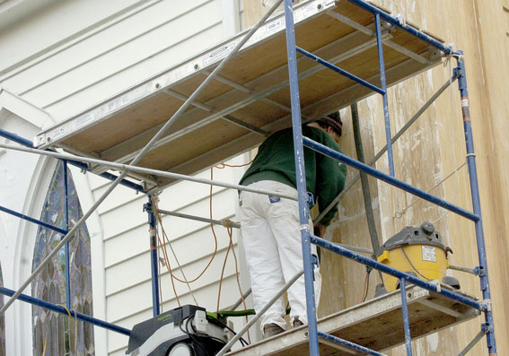 Crews work to remove paint from the Presbyterian church.

DANA SHAW PHOTOS
