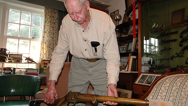 Richard Hendrickson displays a gun from his collection. COLLEEN REYNOLDS
