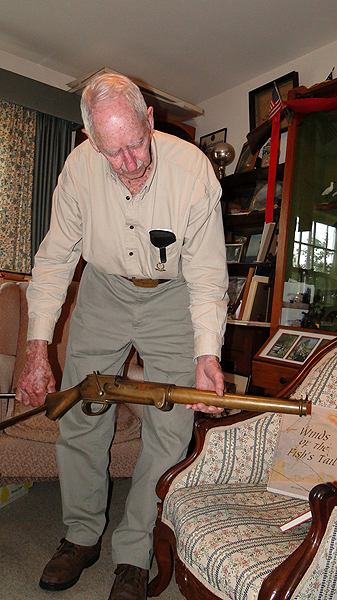 Richard Hendrickson displays a gun from his collection. COLLEEN REYNOLDS