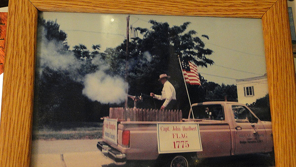 A photograph of a photo in which a younger Richard Hendrickson is blasting a cannon. COLLEEN REYNOLDS