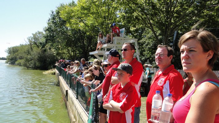 Spectators line Lake Agawam to watch whaleboat racing at the 32nd annual Southampton Fire Department Antique Muster and Parade on Saturday in Southampton Village. COLLEEN REYNOLDS