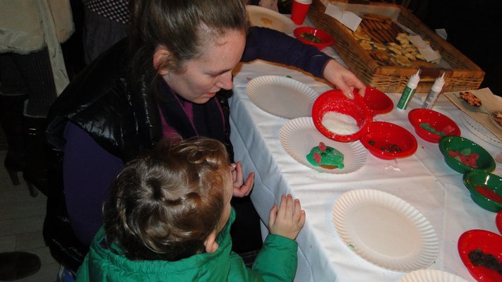  enjoy some cookies at the tree lighting festivities at The Maidstone in East Hampton Village on Sunday. COLLEEN REYNOLDS