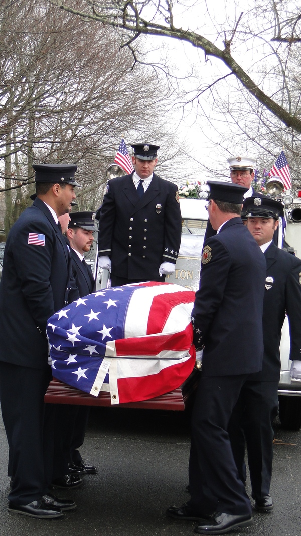 Southampton Fire Department members carry Bill Frankenbach's casket off an Agawam Engine Company truck Saturday morning. COLLEEN REYNOLDS
