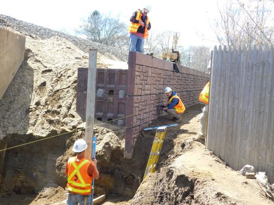 The construction crew was working on building a wall to hold up the tracks on Tuesday afternoon.  ELIZABETH VESPE