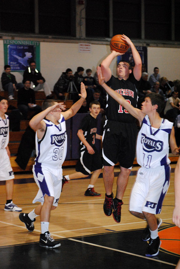  fights for position with a Port Jeff player.