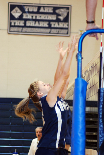Lady Shark Kristen Anderson goes up for a block. 