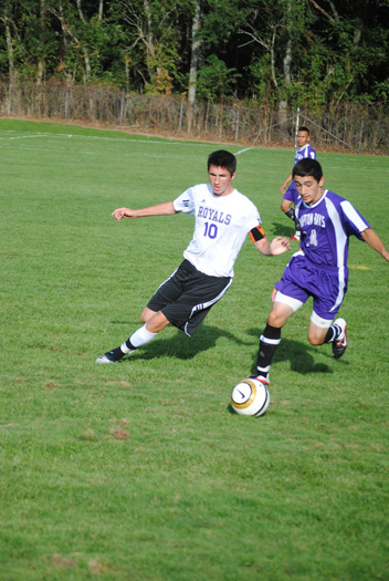 Hampton Bays' Jamie Rincon jockeys for possession with a Port Jeff adversary. 