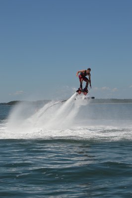 Dane Riva demonstrating for his client's how to turn on the flyboard.