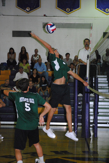 Middle blocker Mike Miracco tries to put a ball away in the Hurricanes' match at Sayville on Friday