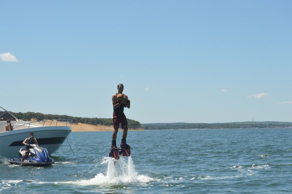 Dane Riva doing flips and jumps while he flyboards over NorthWest creek in Sag Harbor.
