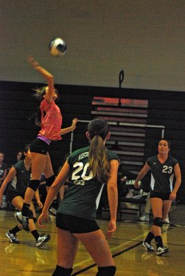 Arianna Brierton leaps to send the ball back over the net. DREW BUDD