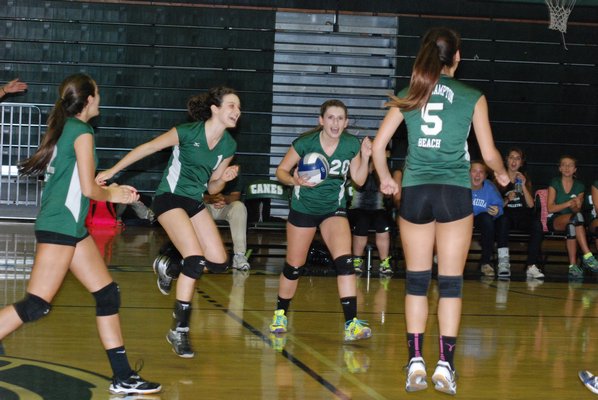 The Lady Hurricanes celebrate a point late in the second set against Sayville on October 1. DREW BUDD