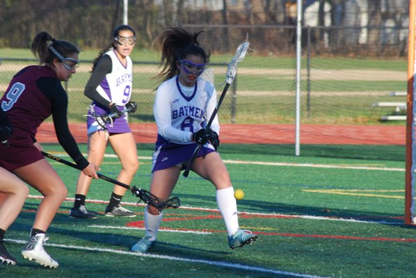 Hampton Bays midfielder Jen Andres forces a turnover. DREW BUDD