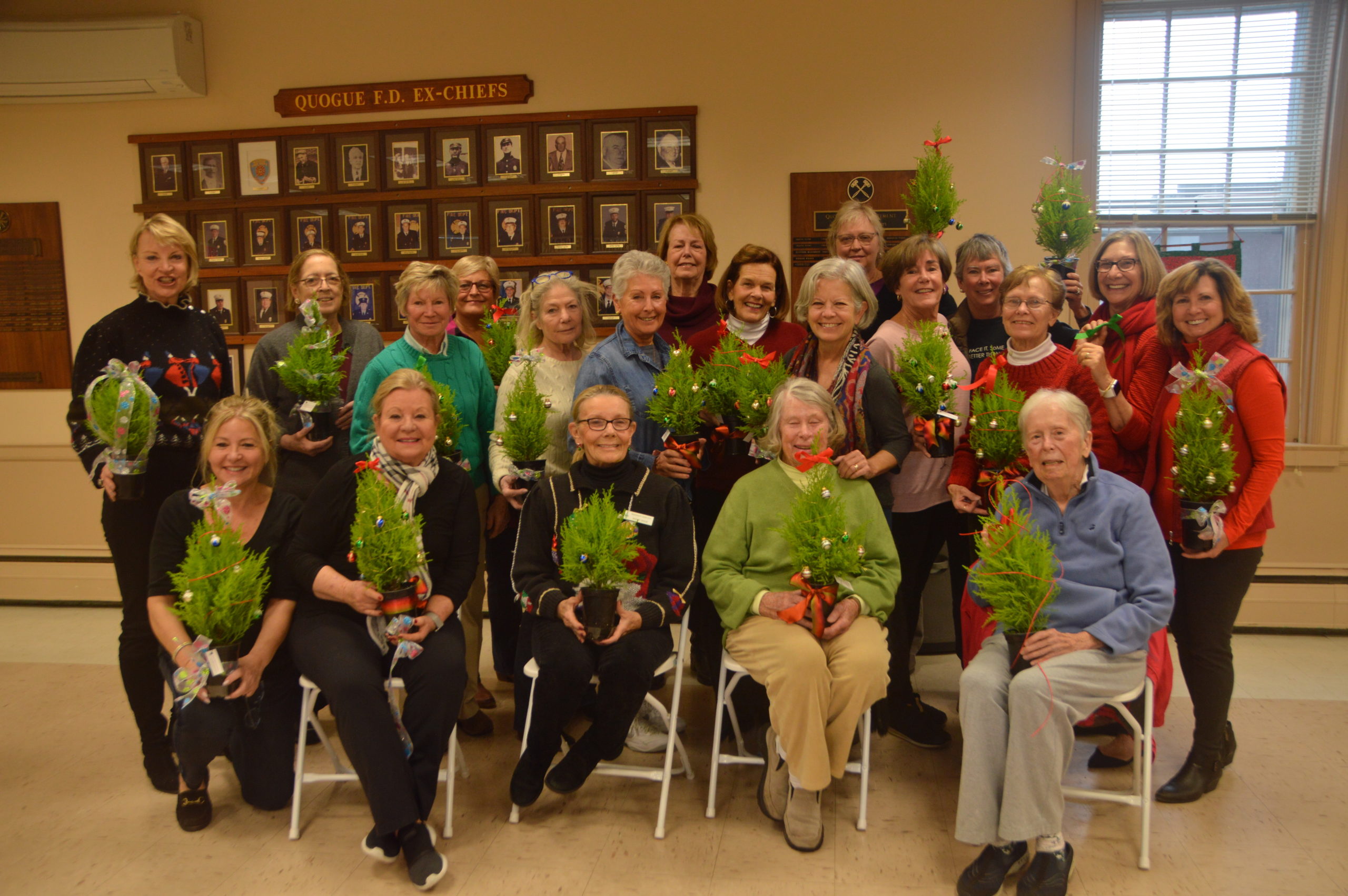 Members of the Westhampton Garden Club gathered at the Quogue Firehouse for the club's annual topiary decorating workshop for East End Hospice. The festively beribboned topiaries will be distributed by the hospice staff to all of of the patients in their care during the holiday season. JUDITH MCDERMOTT