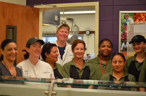 Cheffe Pamela and Cheffe Collette pose with members of the Hampton Bays High School kitchen staff before the first lunch period on Wednesday.