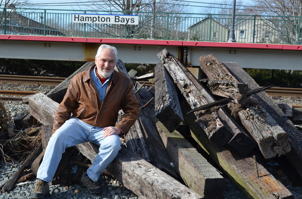 Bruce King sits atop of Long Island Rail Road left over materials at the Hampton Bays train station. 