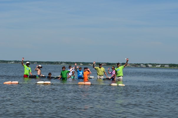 Volunteers for the Moriches Bay Project started an oyster farm on the bay side of Lashley Beach in July. ALEXA GORMAN