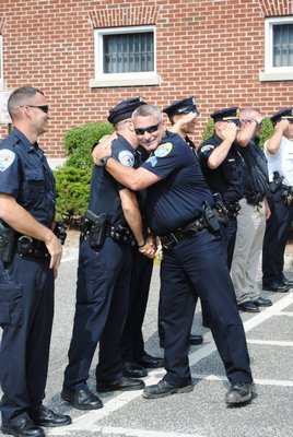 Sergeant Edward Seltenreich shook hands and hugged his fellow co-workers as he exited the Quogue Village Police headquarters for the final time. AMANDA BERNOCCO