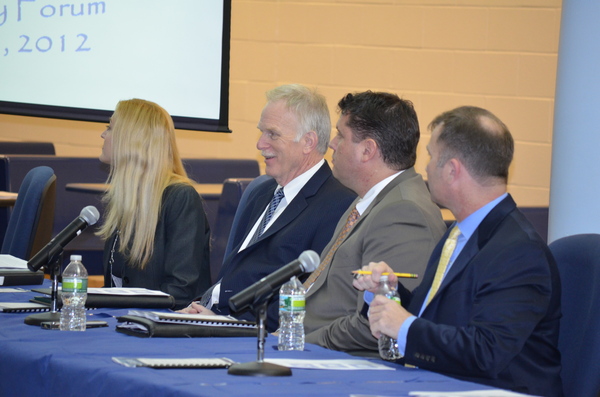 District administrators listen during presentations at a meeting about middle school curriculum changes. 