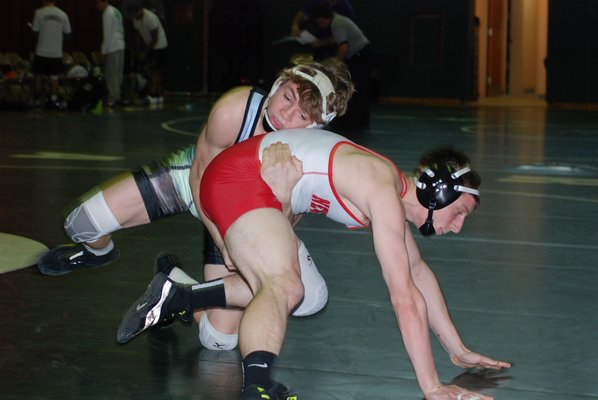 Thatcher Cord works on pinning his Newfield opponent. DREW BUDD