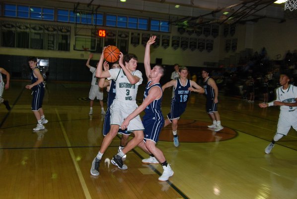 Westhampton Beach junior Nolan Quinlan is surrounded by a pair of Rocky Point defenders. DREW BUDD