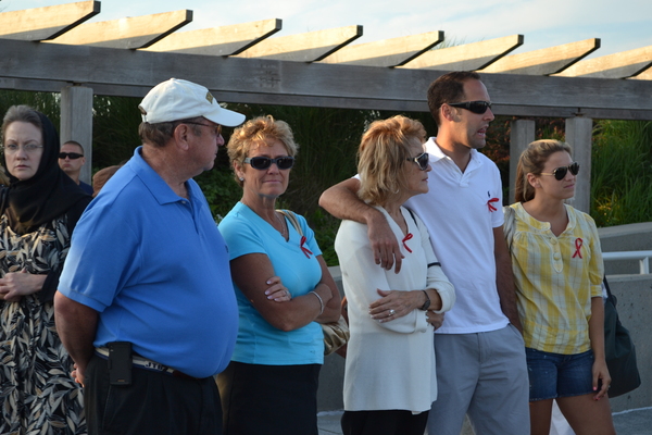 Family members of those lost in the crash of TWA Flight 800 gather at the memorial at Smith Point County park on Sunday night. LAURA COOPER