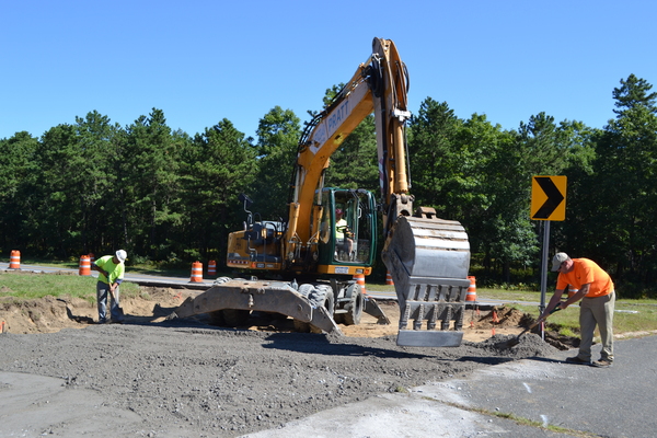 Construction workers from Pratt Brothers Inc. work on the new traffic circle in Flanders on Tuesday morning.