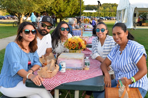 Hayground School in Bridgehampton hosted a benefit picnic on Saturday for Debajo de las Palmas, which helps children and families in the Dominican Republic. Among those attending were, from left, Lina Ramirez, Christian Montes, Dariana Garces, Paola Garces and Zully Ramirez.  KYRIL BROMLEY