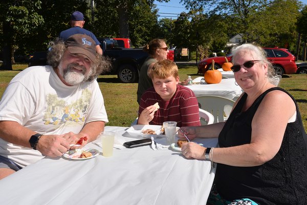 The East Hampton Historical Farm Museum hosted a community dinner on a beautiful Sunday afternoon.  Robert Schurr, Aidan Mansir and Teresa Schurr.  KYRIL BROMLEY