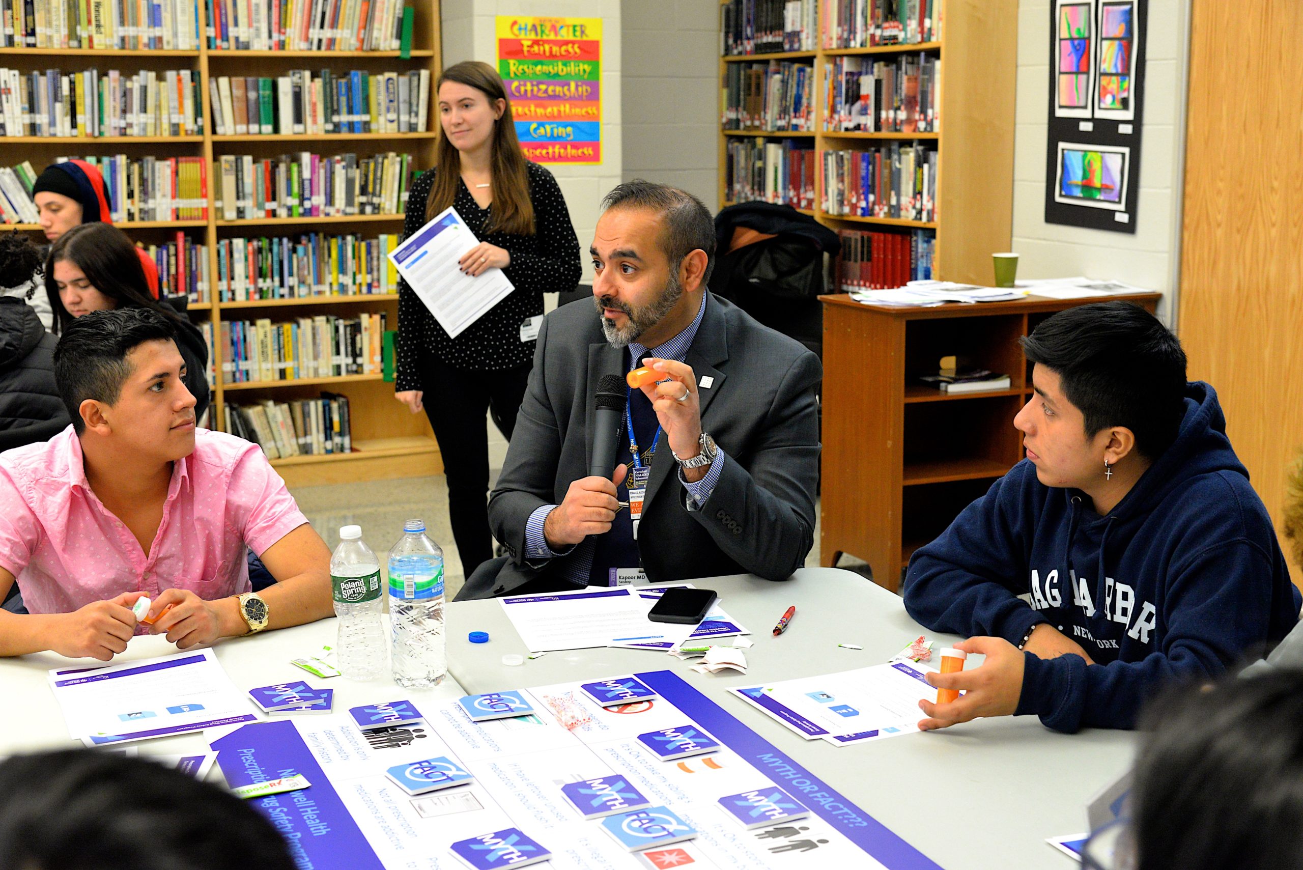 Sandeep Kappor, MD, leads students at one table in a discussion of prescription drug 