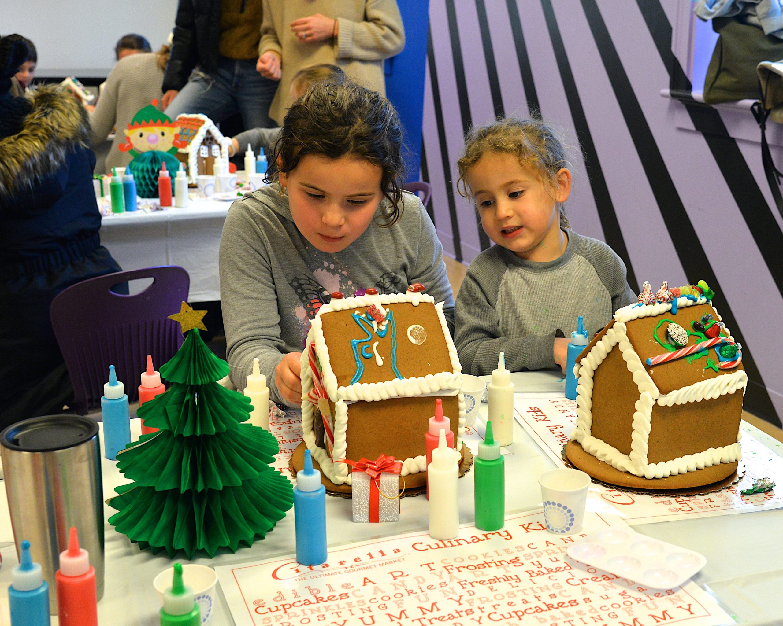 Guild Hall offered an opportunity to get in the holiday spirit by making gingerbread houses on Saturday. Wesley and Louie Bull intent on their work. KYRIL BROMLEY 