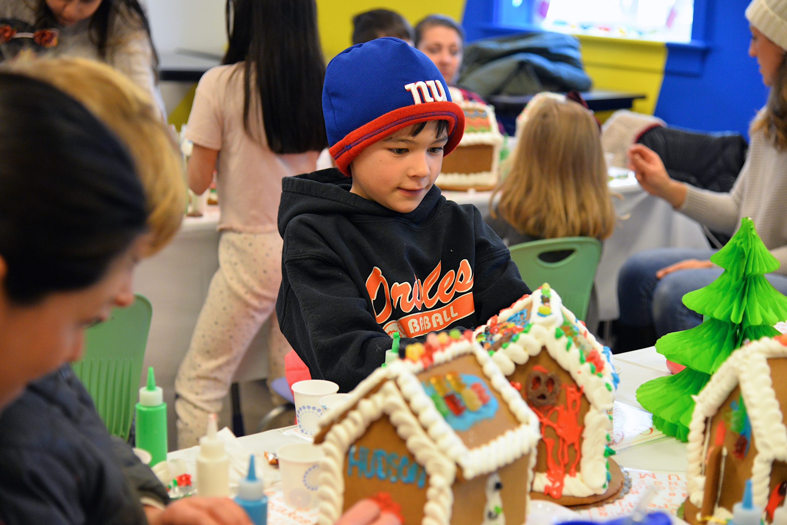 Guild Hall offered an opportunity to get in the holiday spirit by making gingerbread houses on Saturday. Harry Thomas working on his creation. KYRIL BROMLEY 