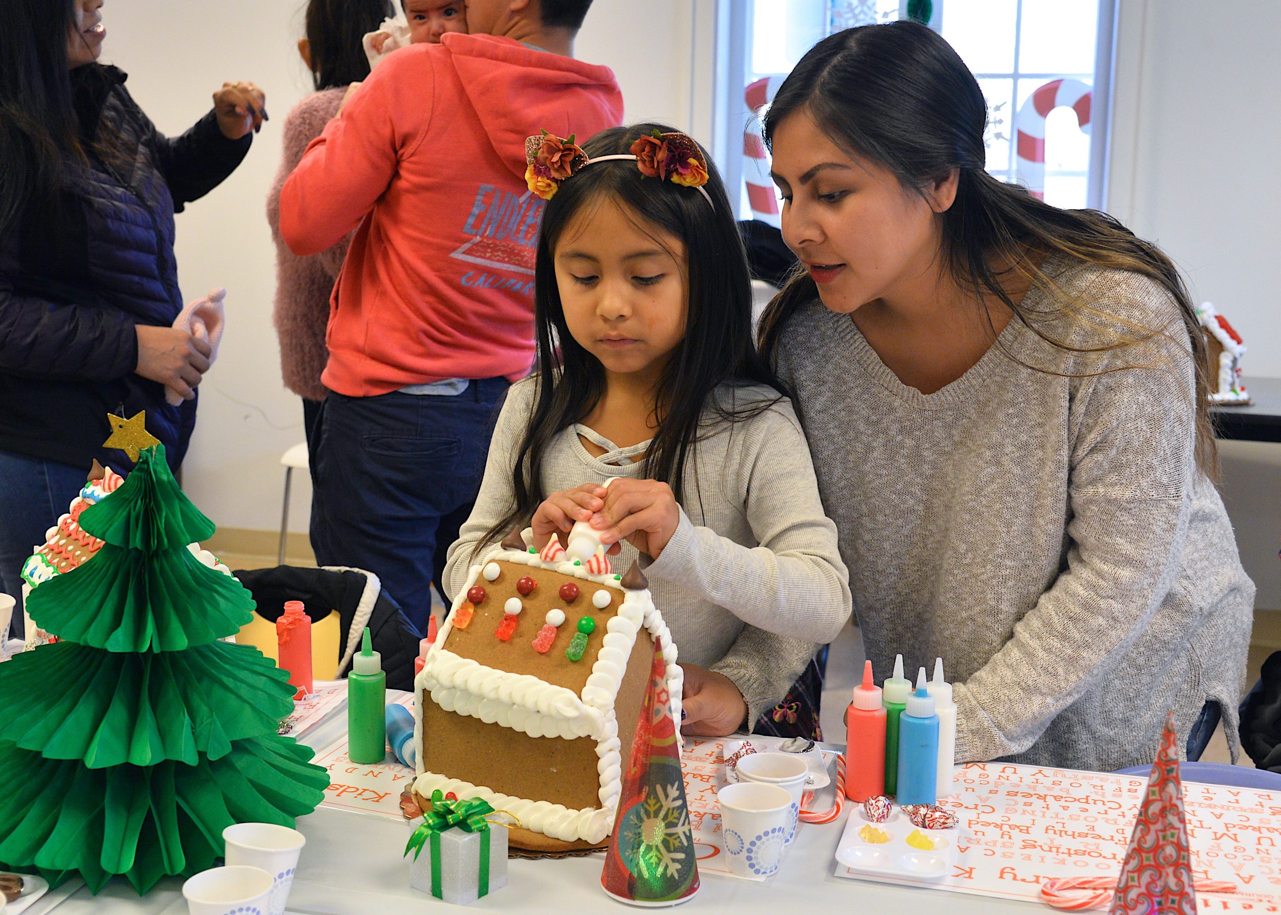 Guild Hall offered an opportunity to get in the holiday spirit by making gingerbread houses on Saturday. Sofia Calle and Andrea Vera working together.  KYRIL BROMLEY 
