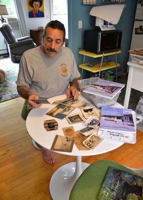 Dell Cullum sifts through some of the old photos he's gathered in recent years. KYRIL BROMLEY