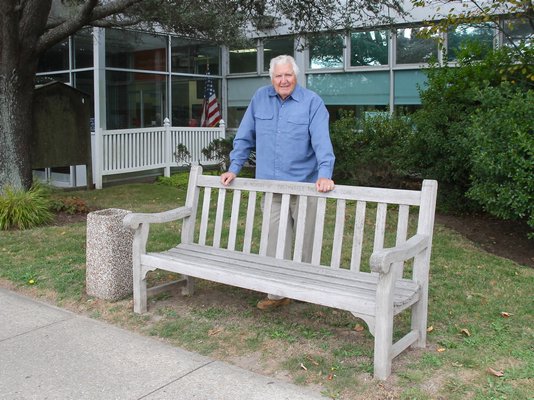 Phil DeFina at the Montauk post office bench that sparked his mission to clean more than 100 benches hamletwide. KYRIL BROMLEY