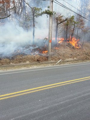 The brush fire at Old Country Road in Eastport on Wednesday. ROB DePIERRO