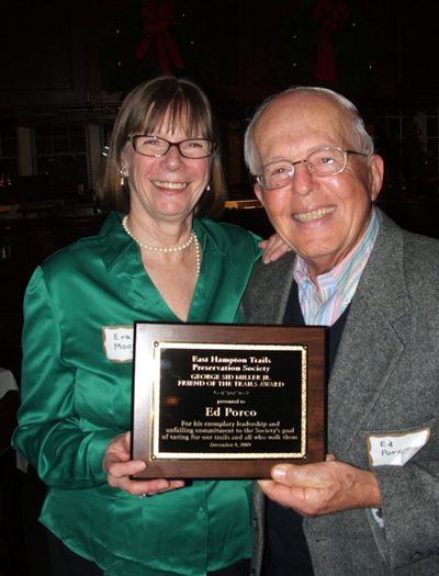 East Hampton Trails Preservation Society President Eva Moore presented Ed Porco with the group's George Sid Miller Jr. Friend of the Trails Award at the annual holiday party at the South Fork Country Club on Friday.