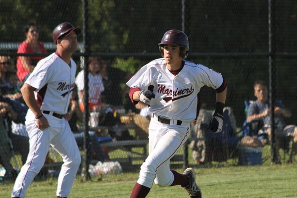 Southampton's Henry Egan scores on Jake Marano's hit in the bottom of the fourth against Wheatley. BRIAN NAUGHTON