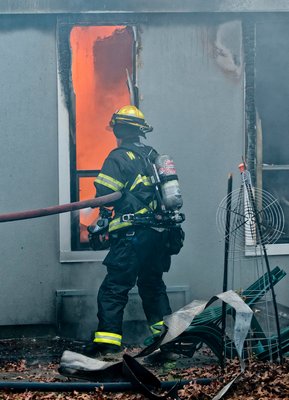Lt. Joe Gordon battles flames during the early stages of the fire. COURTESY WESTHAMPTON BEACH FIRE DEPARTMENT