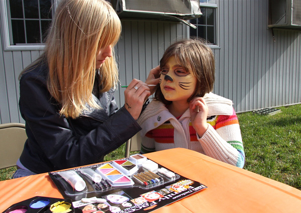 Alexandria Woods gets her face painted by  Rachel Speckenbach at the Child Development Center's Fall Fest on Saturday. KYRIL BROMLEY